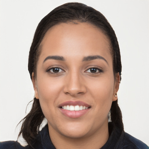 Joyful white young-adult female with long  black hair and brown eyes