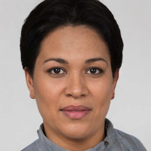 Joyful latino adult female with short  black hair and brown eyes
