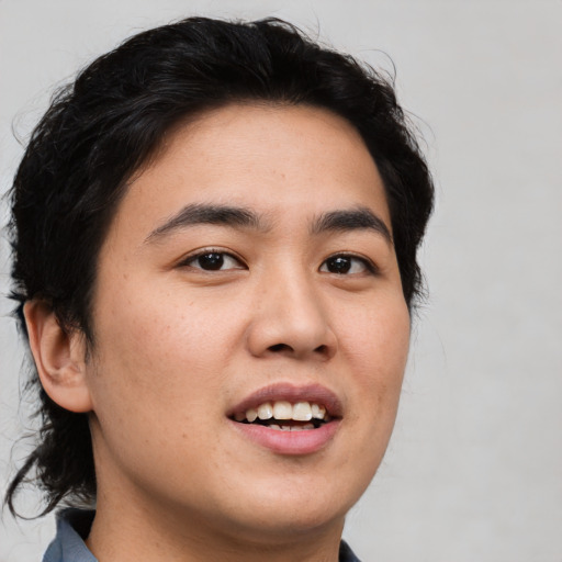 Joyful white young-adult male with medium  brown hair and brown eyes