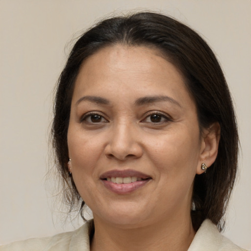 Joyful white adult female with medium  brown hair and brown eyes