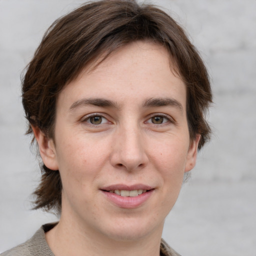 Joyful white young-adult female with medium  brown hair and grey eyes