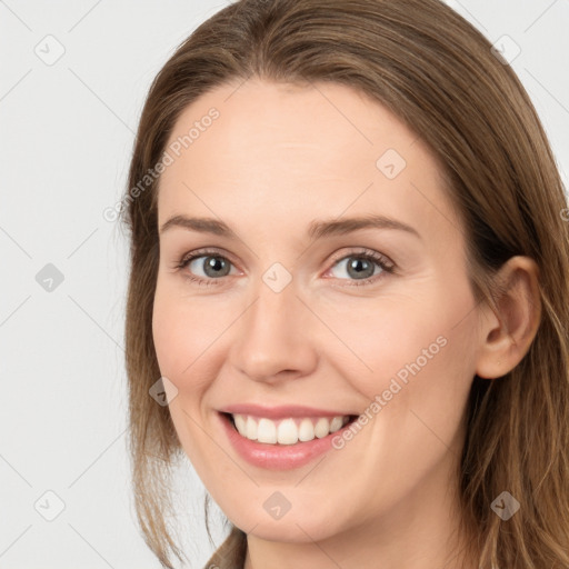 Joyful white young-adult female with long  brown hair and brown eyes