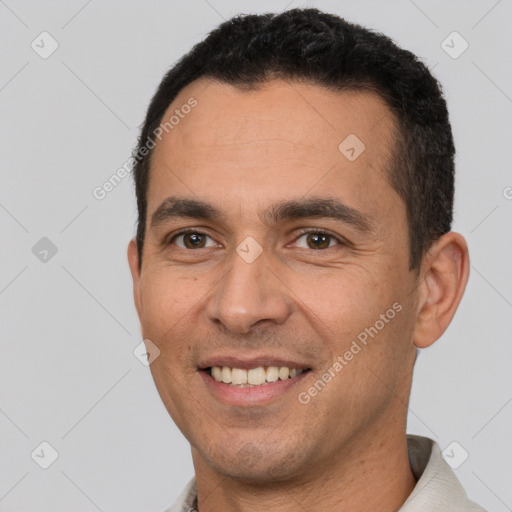 Joyful white young-adult male with short  black hair and brown eyes