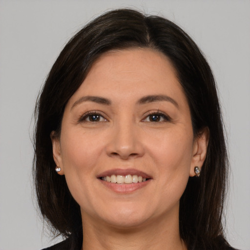 Joyful white adult female with medium  brown hair and brown eyes