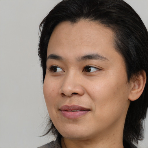 Joyful asian young-adult female with medium  black hair and brown eyes