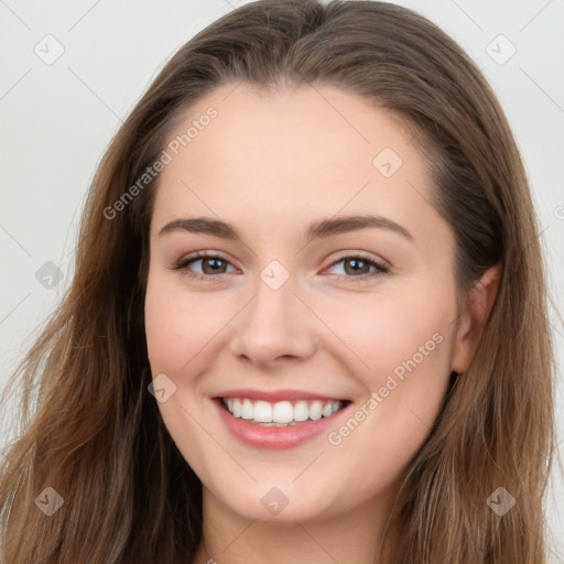 Joyful white young-adult female with long  brown hair and grey eyes