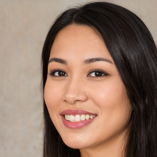 Joyful white young-adult female with long  black hair and brown eyes