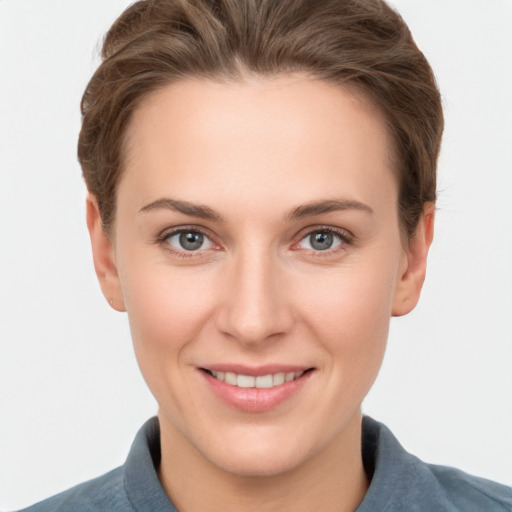 Joyful white young-adult female with short  brown hair and grey eyes