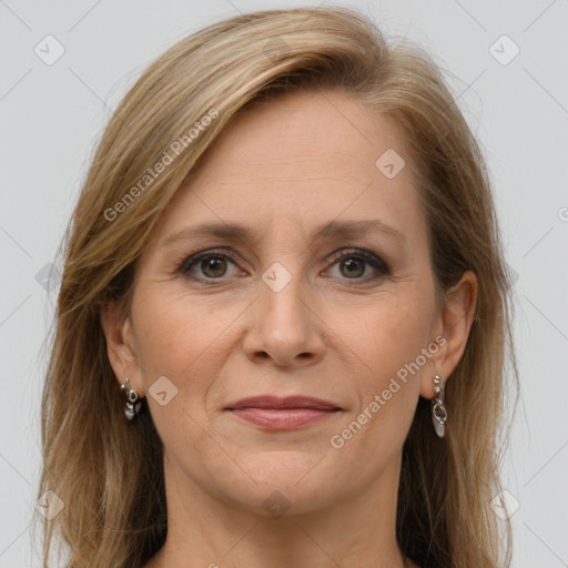 Joyful white adult female with long  brown hair and grey eyes