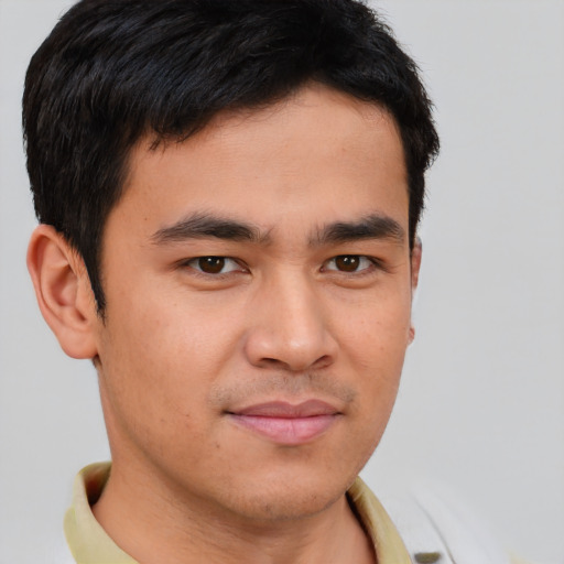 Joyful asian young-adult male with short  brown hair and brown eyes