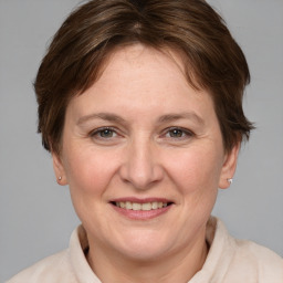 Joyful white adult female with medium  brown hair and grey eyes