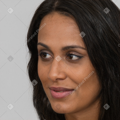 Joyful black young-adult female with long  brown hair and brown eyes