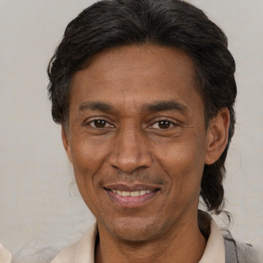 Joyful latino adult male with short  black hair and brown eyes