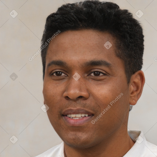 Joyful black young-adult male with short  black hair and brown eyes