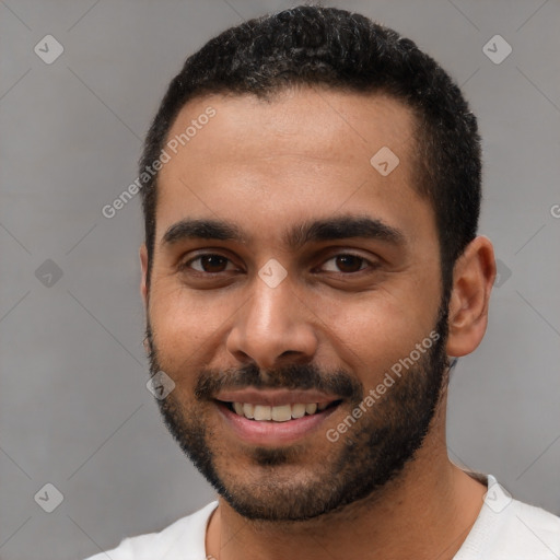 Joyful black young-adult male with short  black hair and brown eyes