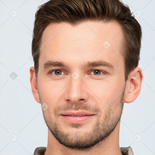 Joyful white young-adult male with short  brown hair and brown eyes