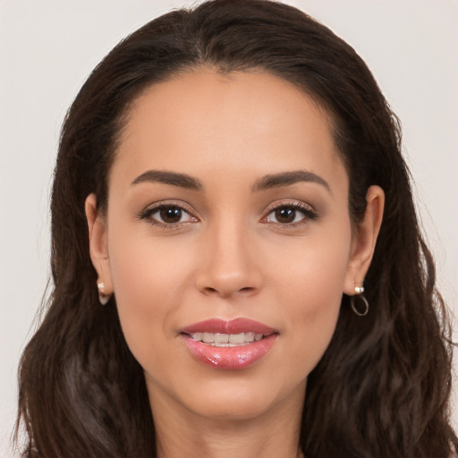 Joyful white young-adult female with long  brown hair and brown eyes