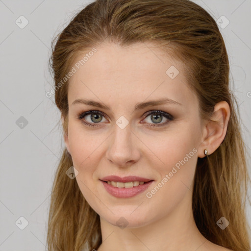 Joyful white young-adult female with long  brown hair and green eyes