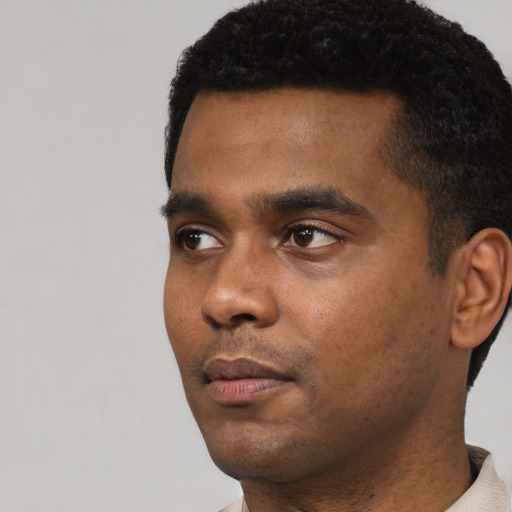 Neutral black young-adult male with short  black hair and brown eyes