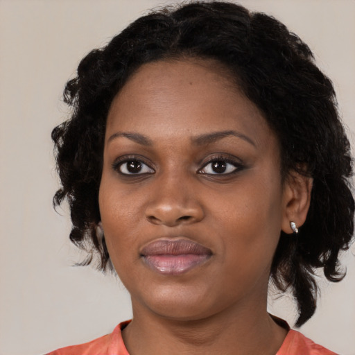 Joyful black young-adult female with medium  black hair and brown eyes