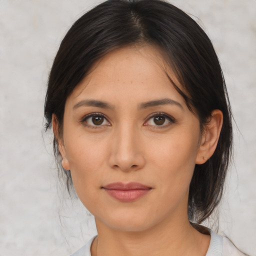 Joyful asian young-adult female with medium  brown hair and brown eyes
