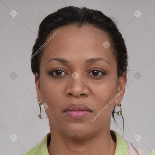 Joyful black adult female with short  brown hair and brown eyes