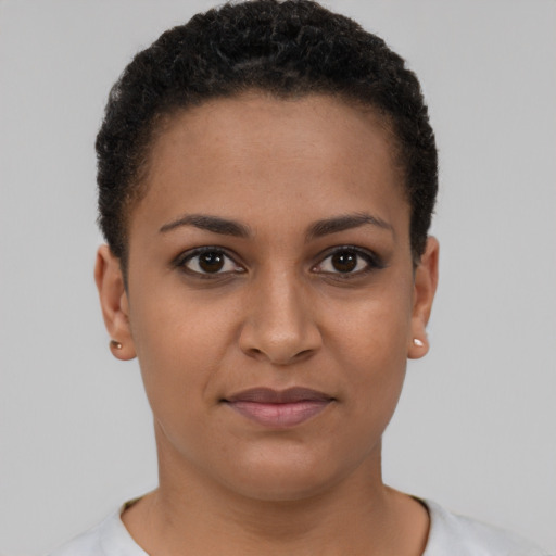 Joyful black young-adult female with short  brown hair and brown eyes