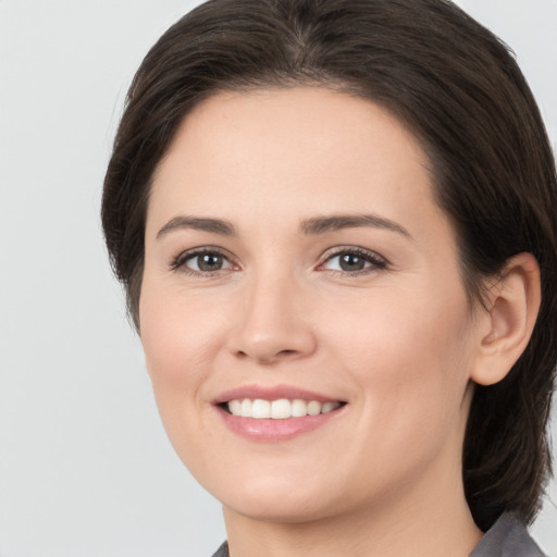 Joyful white young-adult female with medium  brown hair and brown eyes