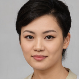 Joyful asian young-adult female with medium  black hair and brown eyes