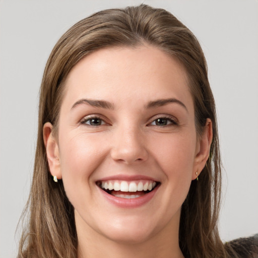 Joyful white young-adult female with long  brown hair and grey eyes