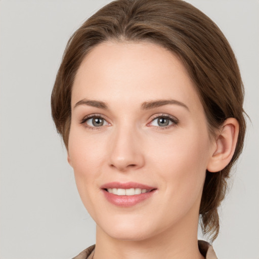 Joyful white young-adult female with medium  brown hair and grey eyes