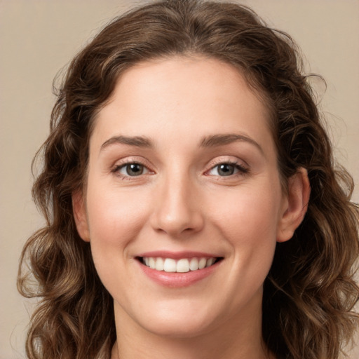 Joyful white young-adult female with long  brown hair and green eyes