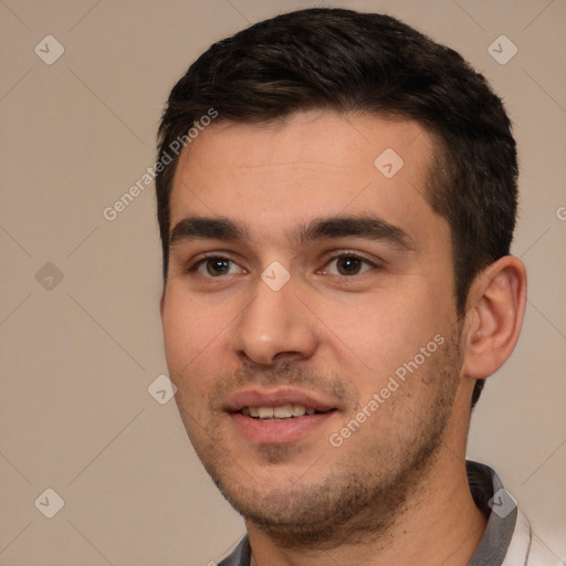 Joyful white young-adult male with short  black hair and brown eyes