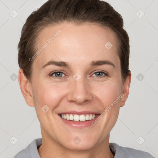 Joyful white young-adult female with short  brown hair and grey eyes