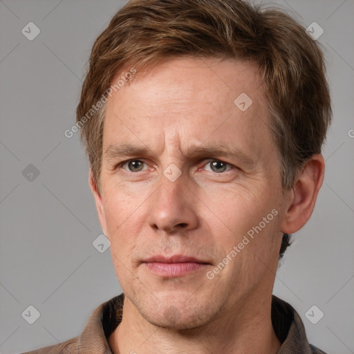 Joyful white adult male with short  brown hair and grey eyes