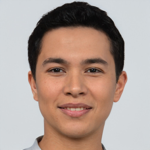 Joyful asian young-adult male with short  black hair and brown eyes