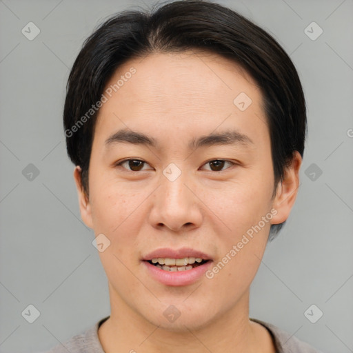 Joyful asian young-adult male with short  brown hair and brown eyes