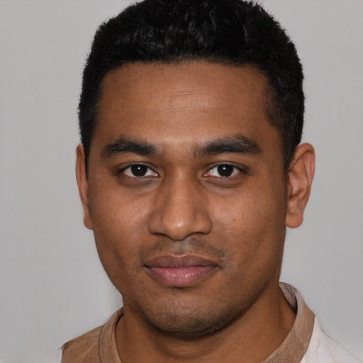 Joyful black young-adult male with short  black hair and brown eyes