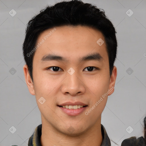 Joyful asian young-adult male with short  black hair and brown eyes