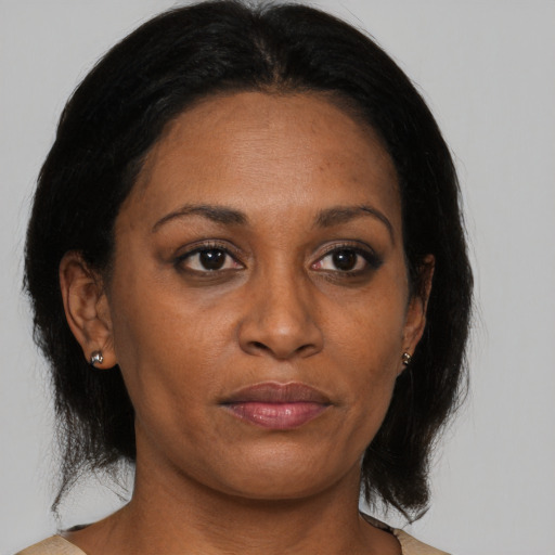 Neutral black adult female with medium  brown hair and brown eyes