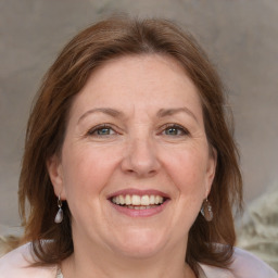 Joyful white adult female with medium  brown hair and grey eyes