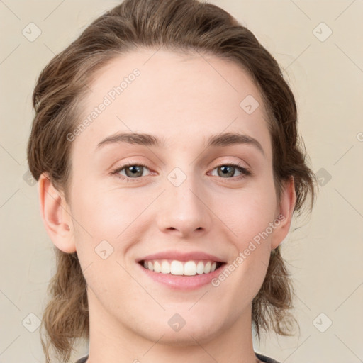 Joyful white young-adult female with medium  brown hair and green eyes