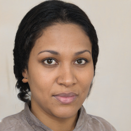 Joyful black young-adult female with medium  brown hair and brown eyes
