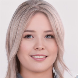 Joyful white young-adult female with long  brown hair and blue eyes