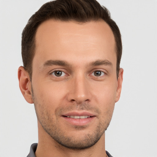 Joyful white young-adult male with short  brown hair and brown eyes