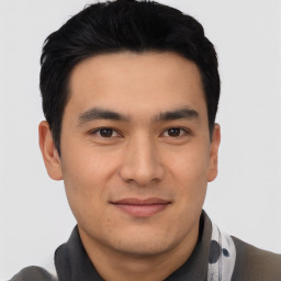 Joyful asian young-adult male with short  black hair and brown eyes