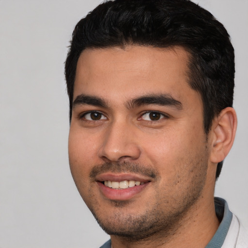 Joyful white young-adult male with short  black hair and brown eyes