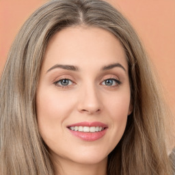 Joyful white young-adult female with long  brown hair and green eyes