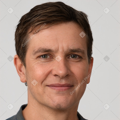 Joyful white adult male with short  brown hair and grey eyes