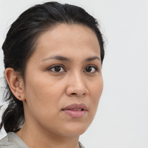 Joyful latino young-adult female with medium  brown hair and brown eyes